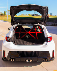 Thumbnail for GR Corolla bolt-in roll bar from CMS Performance viewed through the open rear hatch