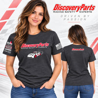 Thumbnail for A woman modeling a dark heather gray DiscoveryParts t-shirt, showing both front and back views. The front features a red and white DiscoveryParts logo, a white race car graphic, and sponsor logos on the sleeve.