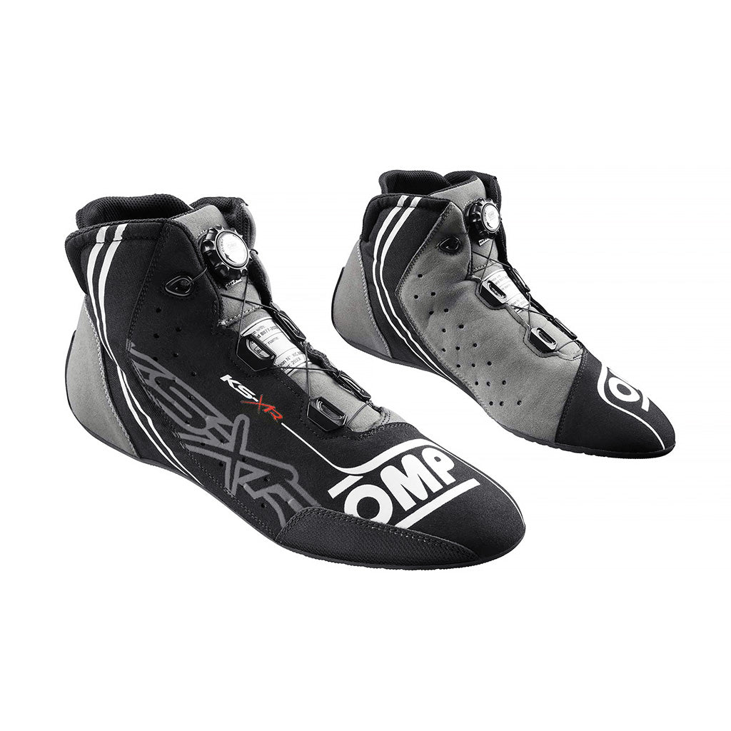 Pair of black and gray racing shoes with OMP branding on a white background