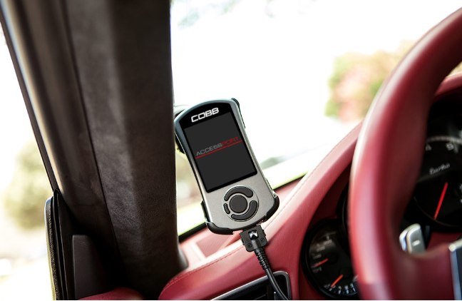 COBB Accessport V3 handheld device on Porsche dashboard