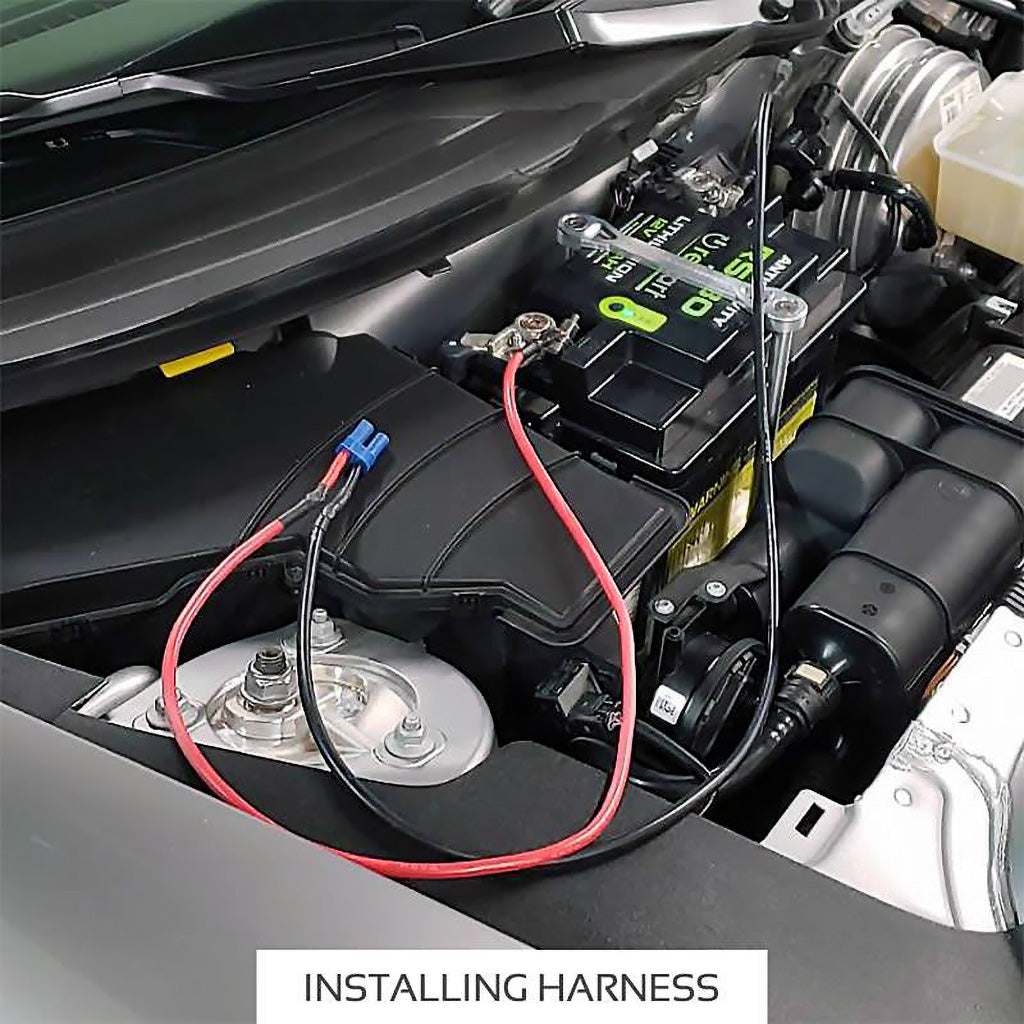 Long 45-inch Antigravity clampless starting harness tucked near car cowl for jump-starting