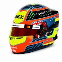 Thumbnail for Oscar Piastri 2026 F1 mini helmet angled left view with McLaren branding and collector display box