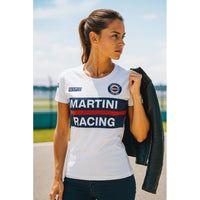 Thumbnail for Woman wearing a white 'Martini Racing' shirt outdoors with a clear sky.