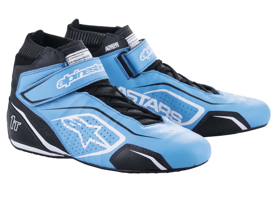 A pair of Alpinestars Tech-1 T v3 racing shoes, featuring blue and black colors with suede and leather construction, a lace-up closure, and a rubber sole.